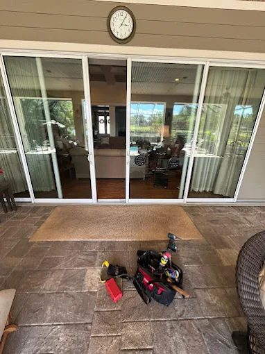Multi-panel sliding door job site with tools staged on the patio