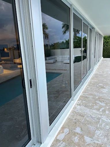 Newly installed sliding glass doors along a pool deck