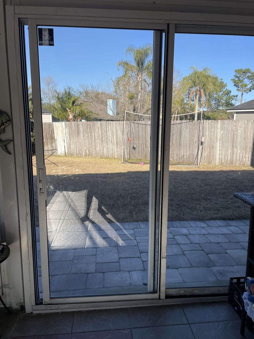 Finished sliding glass door overlooking a backyard