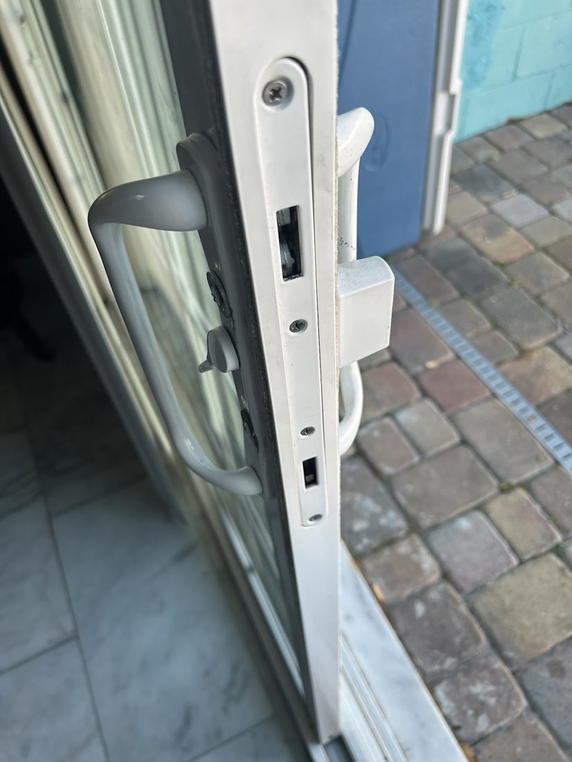 Close-up of a sliding door handle and lock hardware