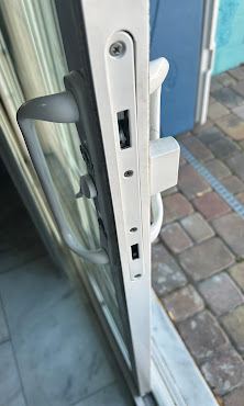 Worn sliding door lock and handle before replacement