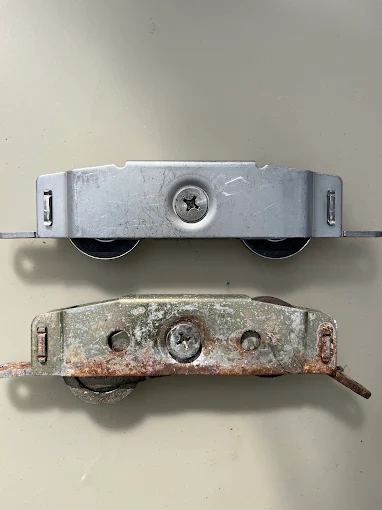 New roller assembly next to the old, corroded roller it replaced