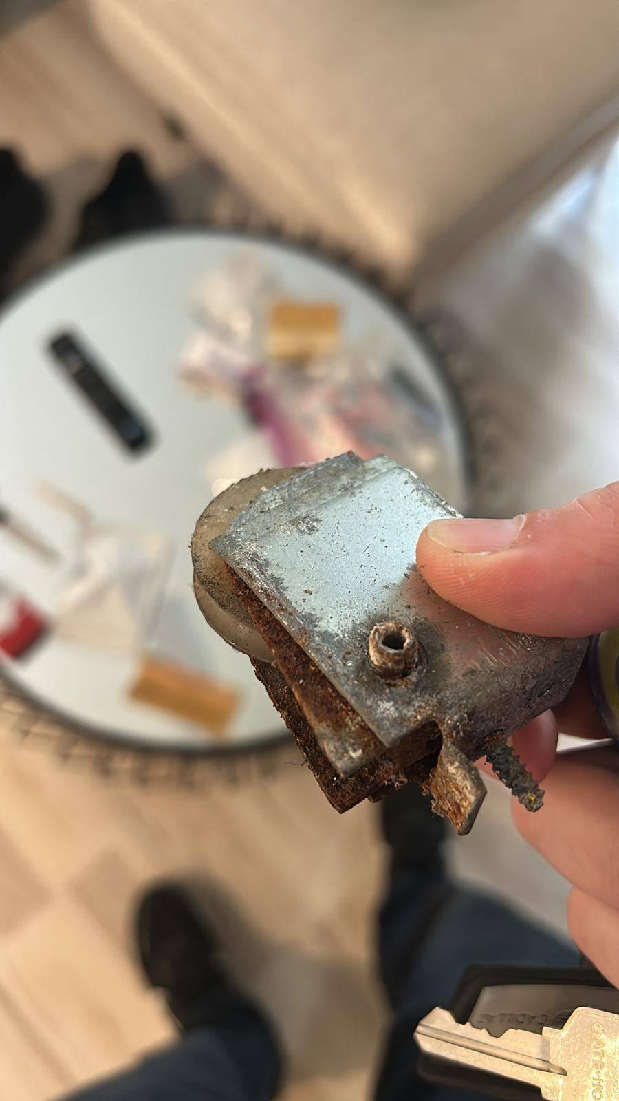 Corroded sliding door roller before replacement